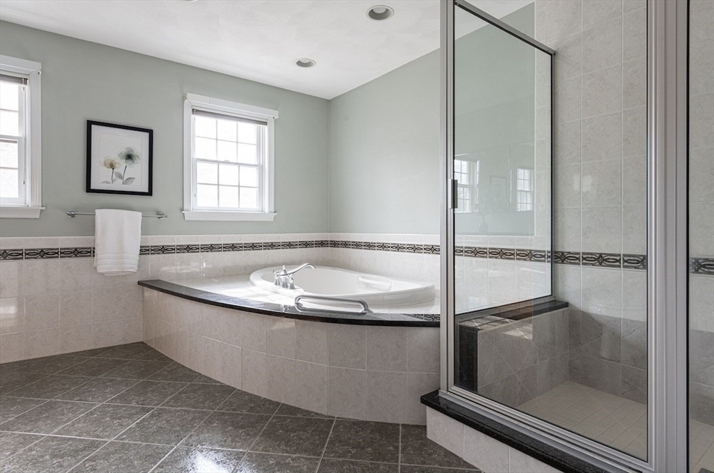 21 Bryant Road Lexington, MA 02420 - Photo 23 of 33 a bathroom with a granite countertop bathtub and a shower