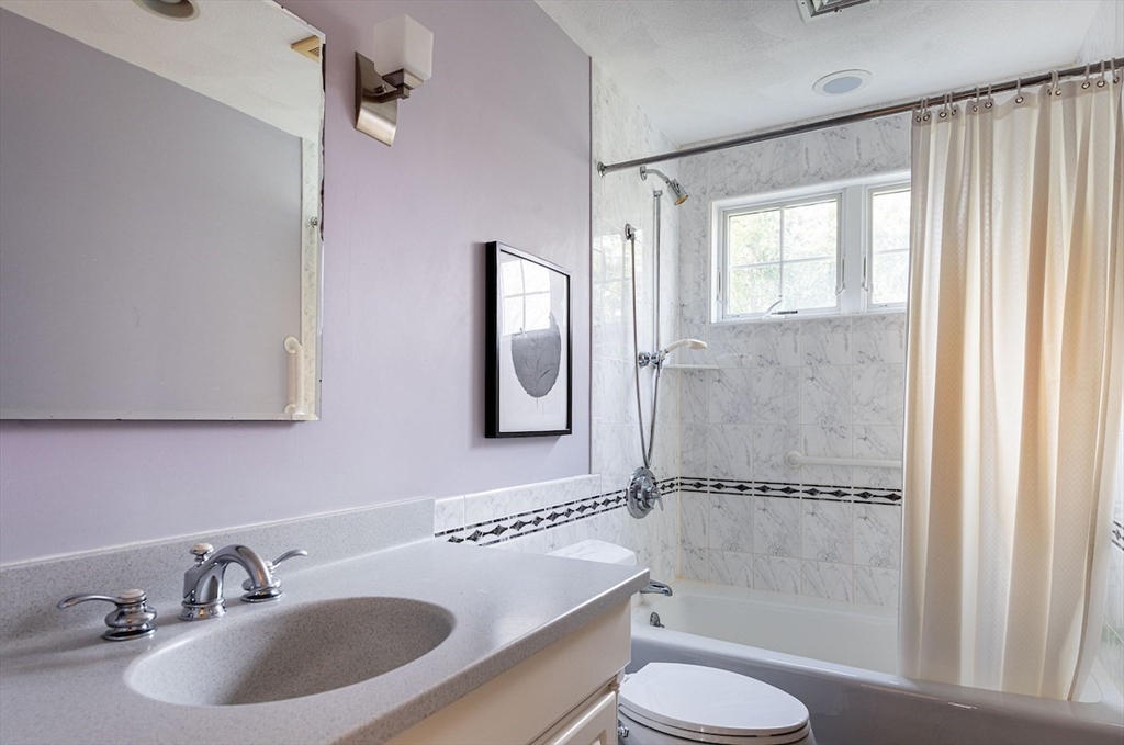 21 Bryant Road Lexington, MA 02420 - Photo 28 of 33 a bathroom with a sink toilet a mirror and shower