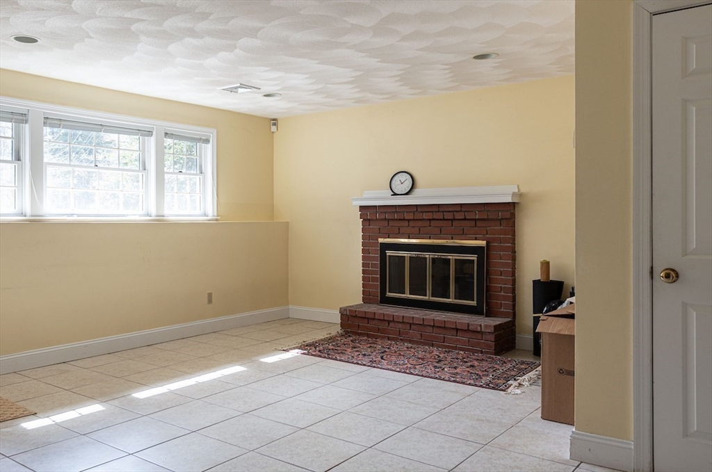21 Bryant Road Lexington, MA 02420 - Photo 30 of 33 a living room with a fireplace