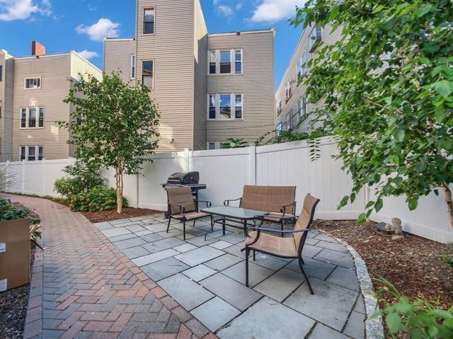 a view of a patio with table and chairs and potted plants