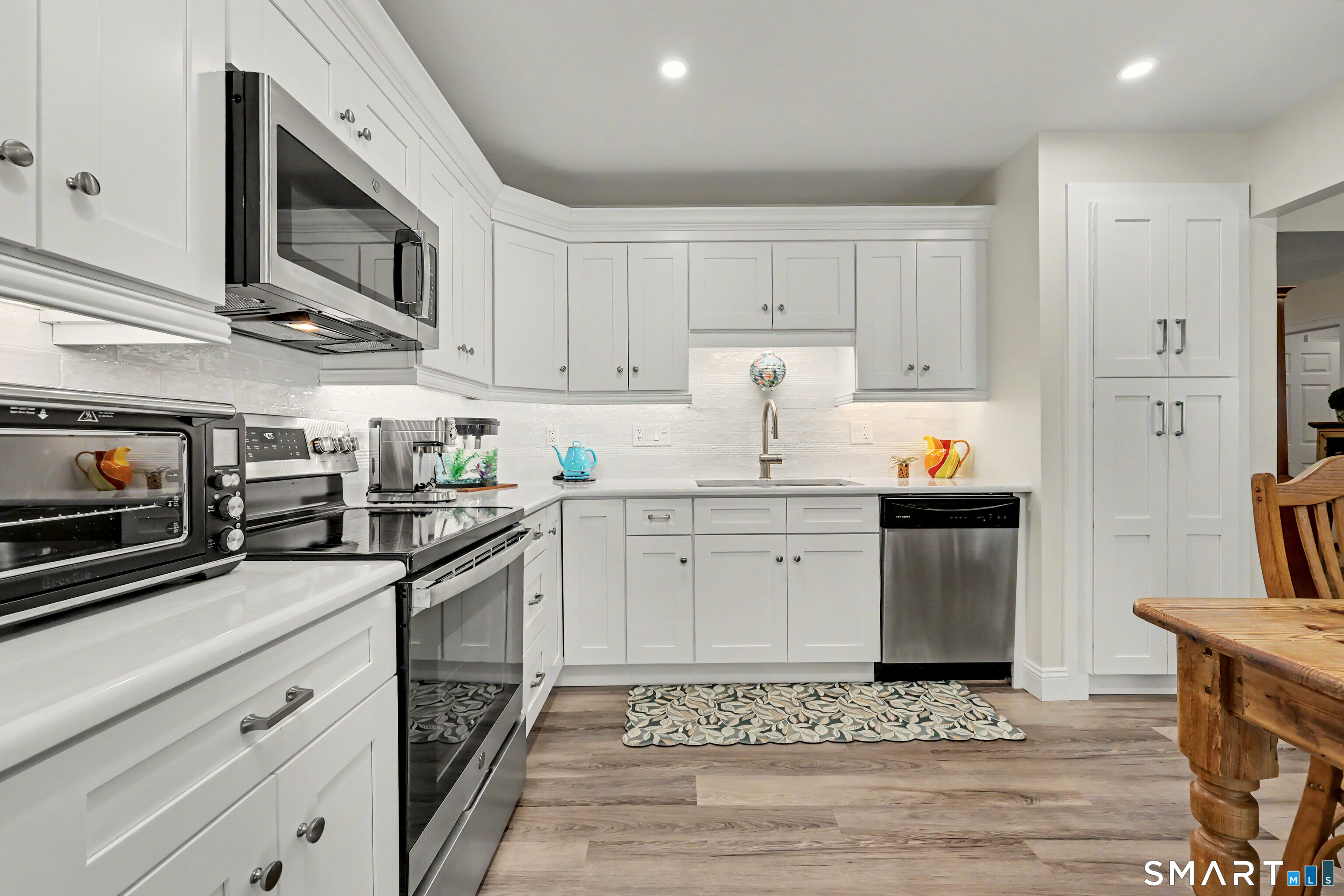 70 Fawn Ridge Lane, Unit 70 Norwalk, CT 06851 - Photo 8 of 36 a kitchen with granite countertop stainless steel appliances and wooden cabinets