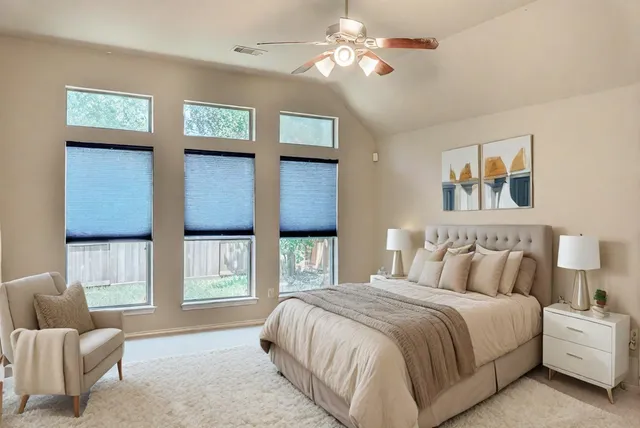 a spacious bedroom with a bed and a couch