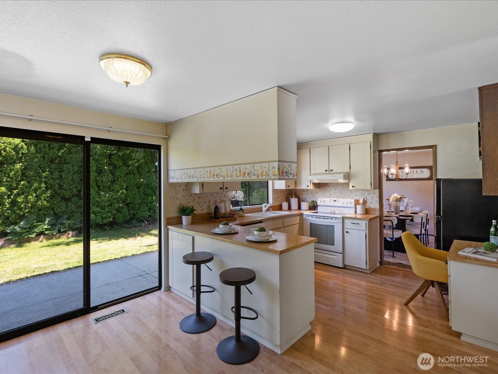 12314 Northeast 162nd Street Bothell, WA 98011 - Photo 14 of 39 a room with kitchen island a large window cabinets and stainless steel appliances