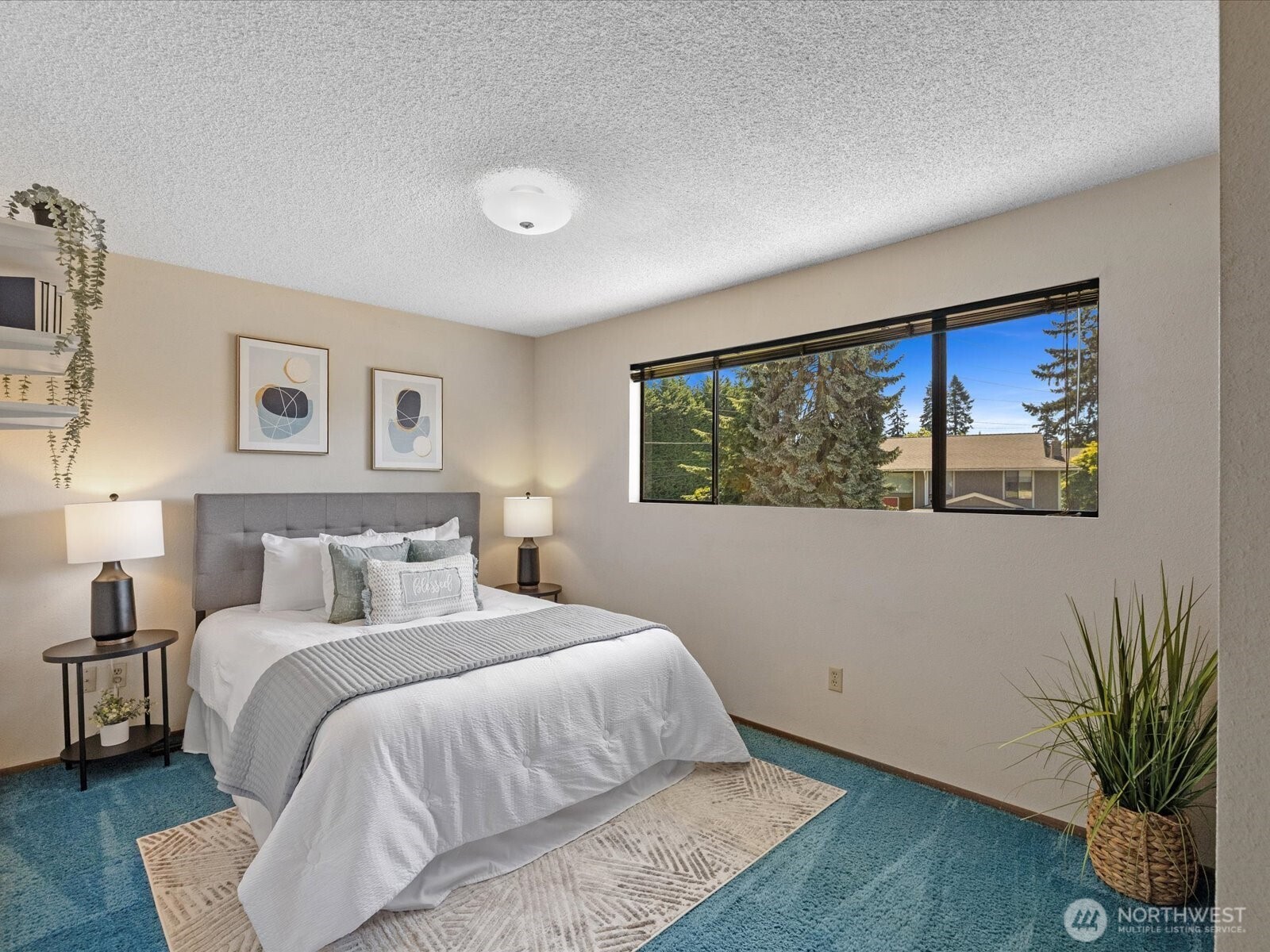 12314 Northeast 162nd Street Bothell, WA 98011 - Photo 31 of 39 a bedroom with a large bed and a potted plant