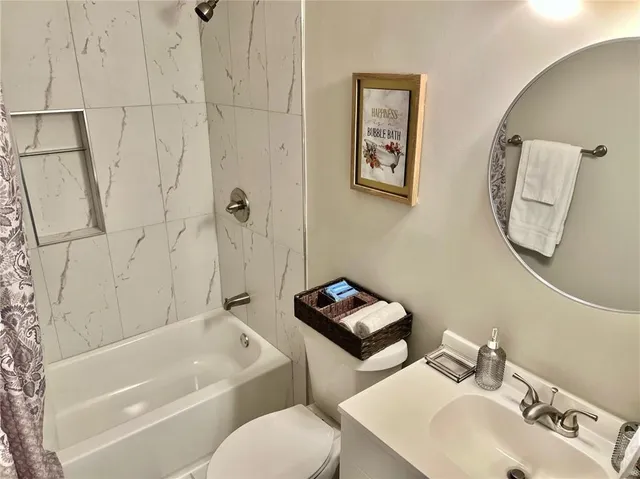 a bathroom with a toilet sink and a bathtub