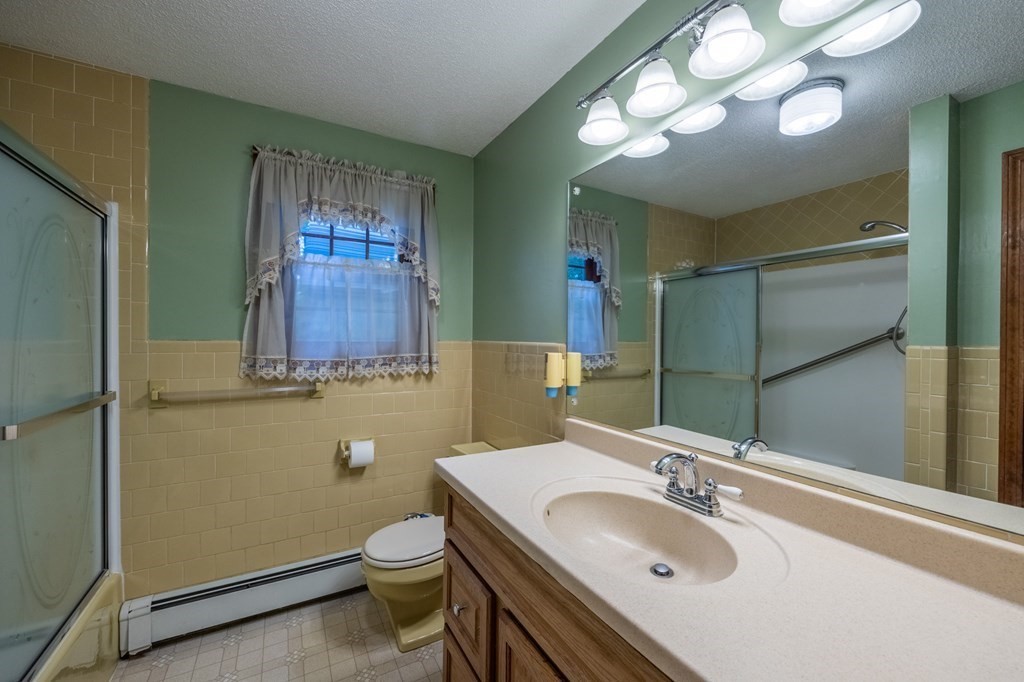 658 Middle Road Acushnet, MA 02743 - Photo 20 of 32 a bathroom with a sink a toilet and mirror