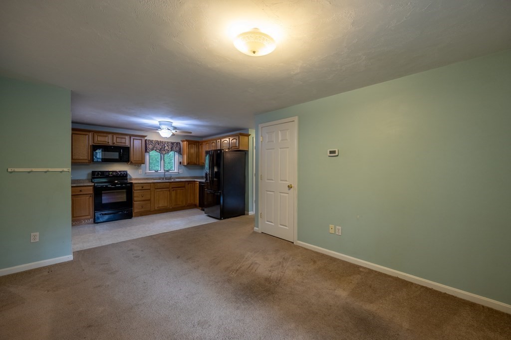 658 Middle Road Acushnet, MA 02743 - Photo 22 of 32 a view of a kitchen with a sink and a refrigerator
