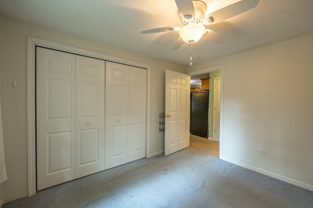658 Middle Road Acushnet, MA 02743 - Photo 26 of 32 an empty room with a chandelier fan and closet area