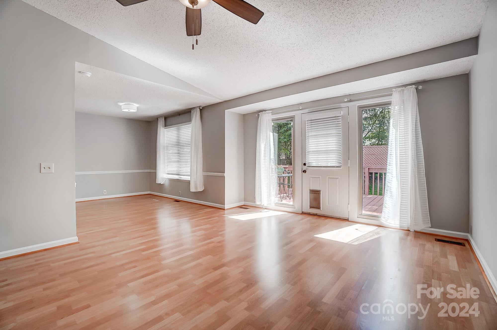 6510 Patchwork Circle Charlotte, NC 28270 - Photo 12 of 48 an empty room with wooden floor and windows