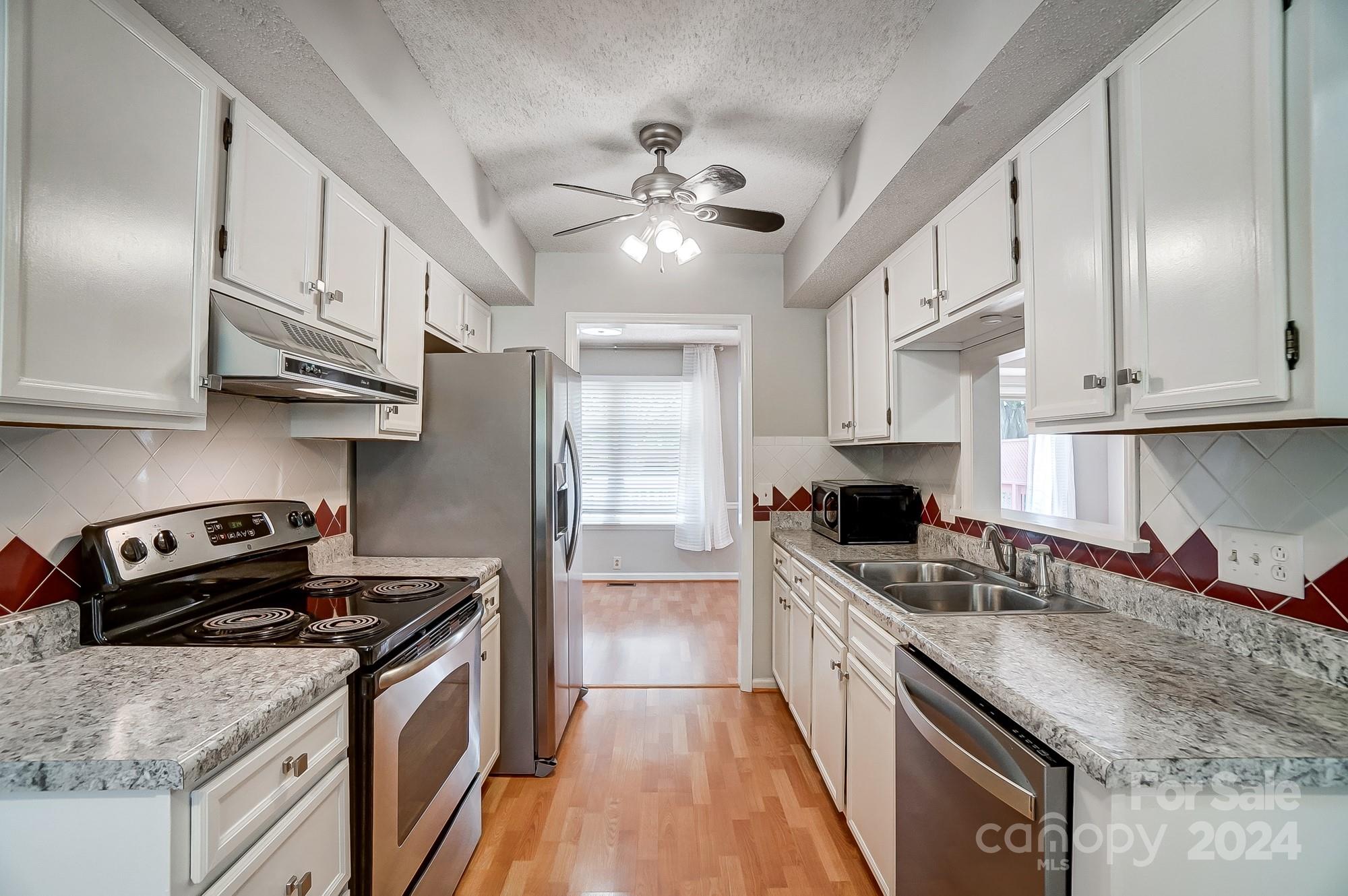 6510 Patchwork Circle Charlotte, NC 28270 - Photo 13 of 48 a kitchen with stainless steel appliances granite countertop a sink a stove and a refrigerator