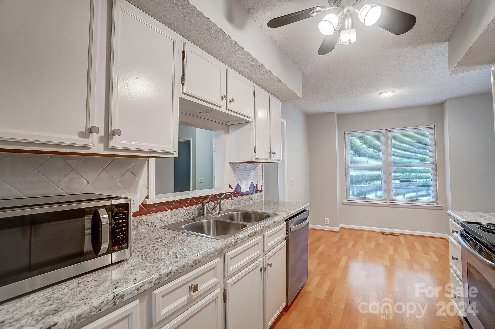 6510 Patchwork Circle Charlotte, NC 28270 - Photo 15 of 48 a kitchen with stainless steel appliances granite countertop a sink and a stove