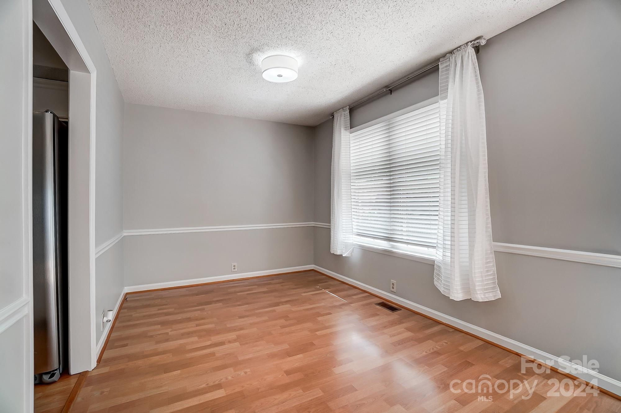6510 Patchwork Circle Charlotte, NC 28270 - Photo 20 of 48 a view of empty room with wooden floor and fan