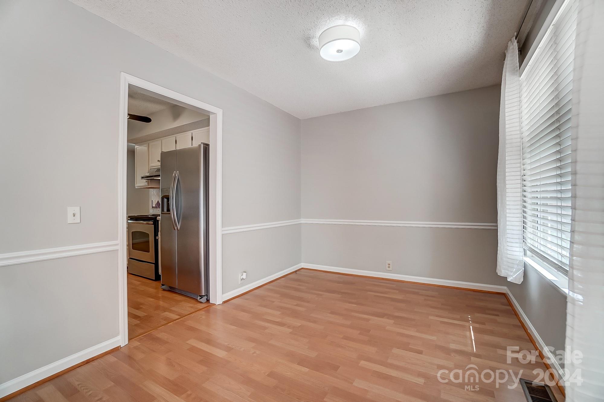 6510 Patchwork Circle Charlotte, NC 28270 - Photo 21 of 48 a view of an empty room with a window and wooden floor