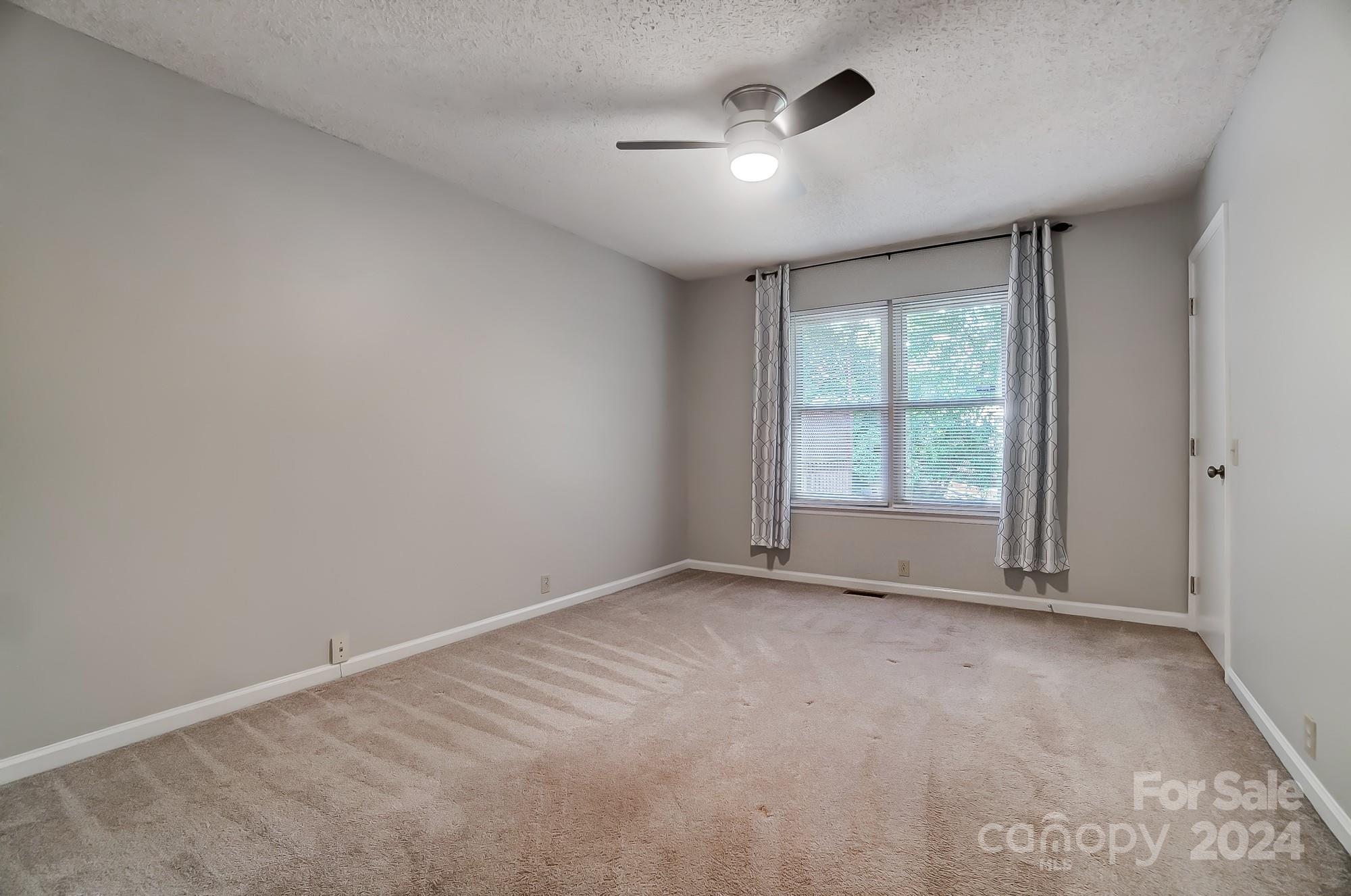 6510 Patchwork Circle Charlotte, NC 28270 - Photo 24 of 48 an empty room with windows and fan