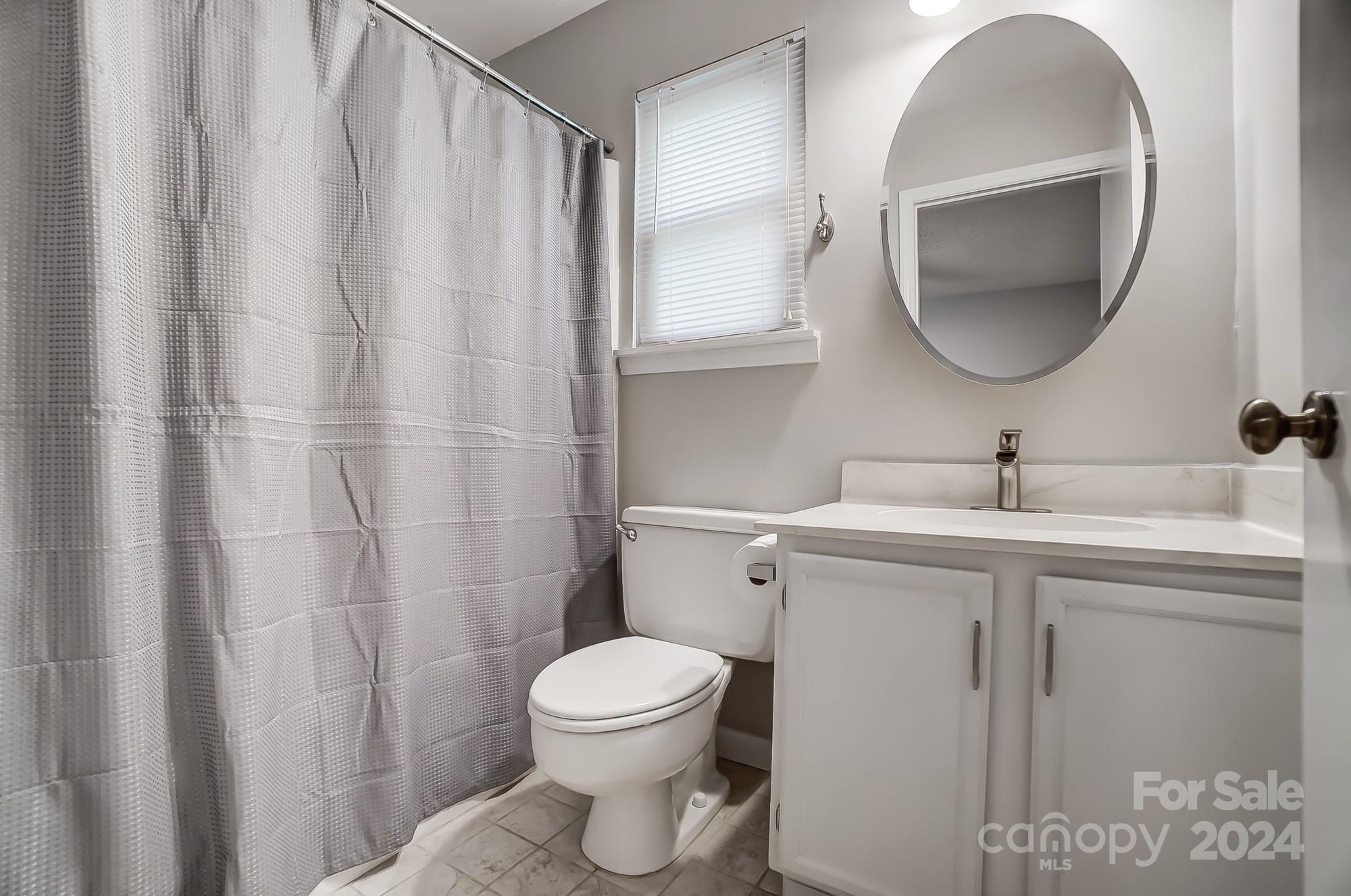 6510 Patchwork Circle Charlotte, NC 28270 - Photo 27 of 48 a bathroom with a toilet a sink and curtain