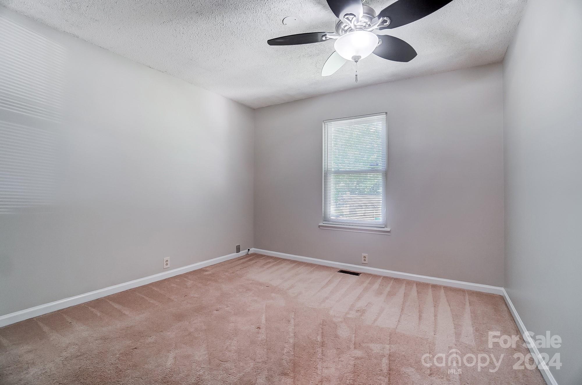 6510 Patchwork Circle Charlotte, NC 28270 - Photo 29 of 48 an empty room with a window and a fan