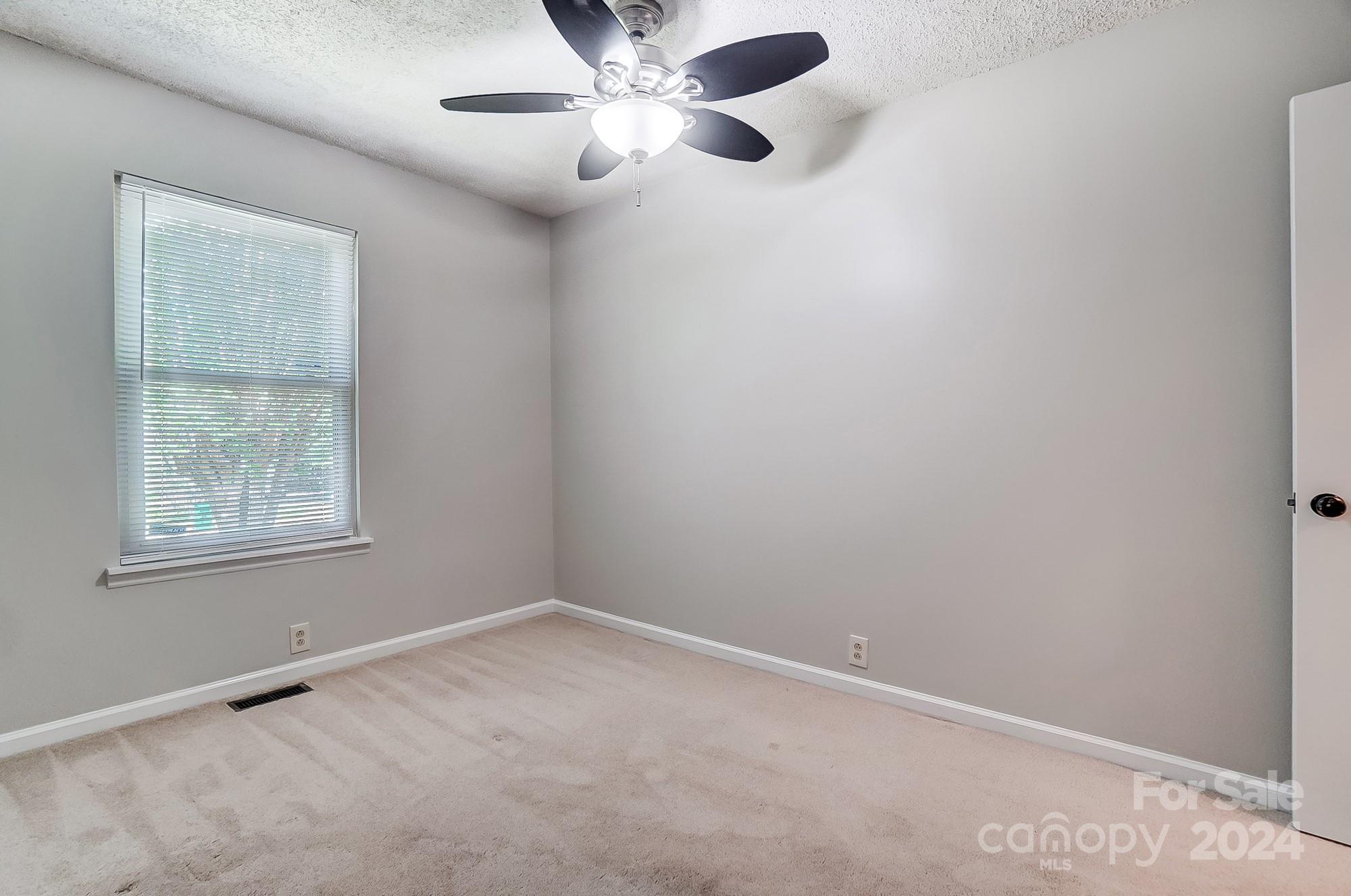 6510 Patchwork Circle Charlotte, NC 28270 - Photo 30 of 48 an empty room with a window and a fan