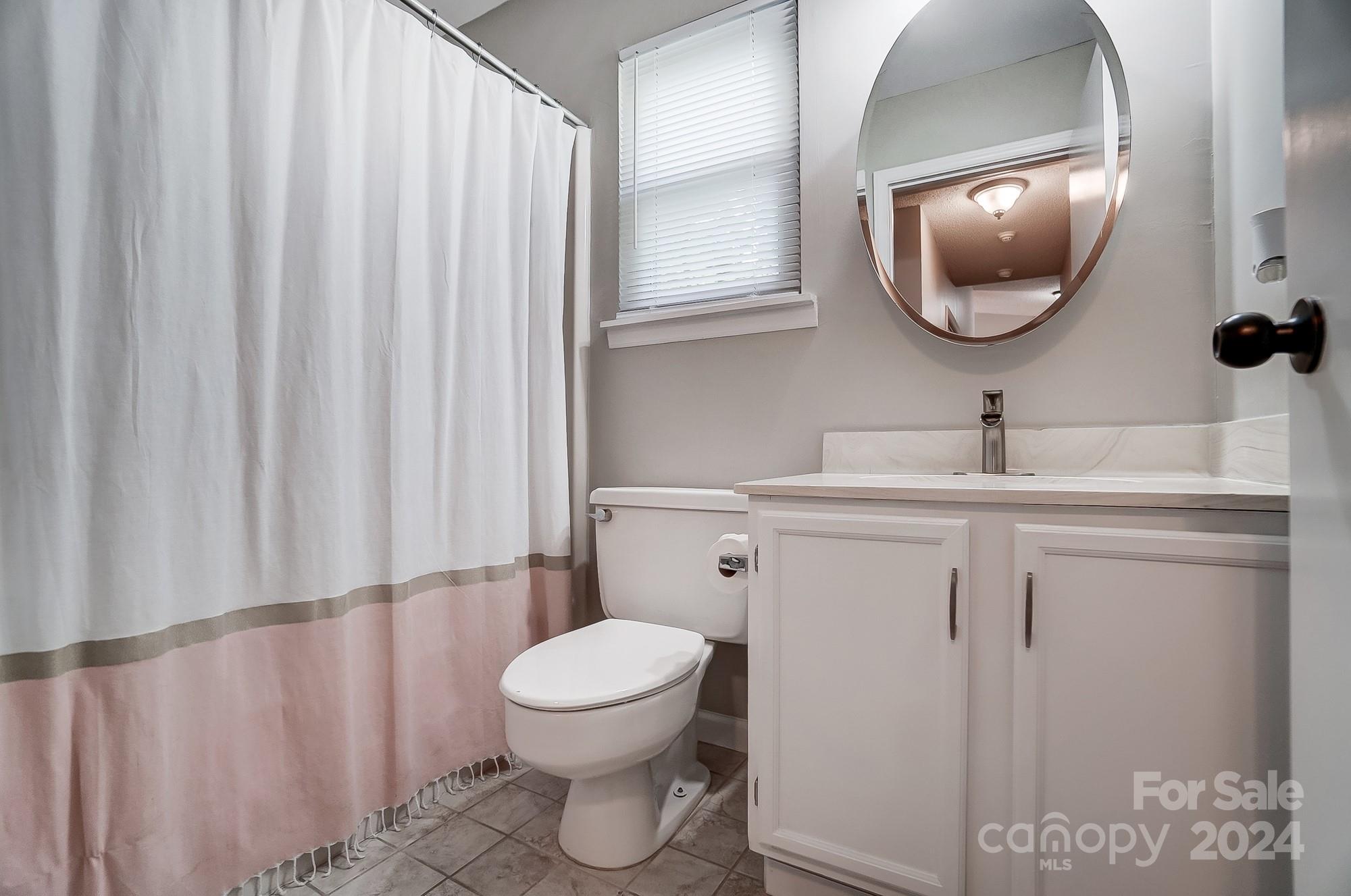 6510 Patchwork Circle Charlotte, NC 28270 - Photo 31 of 48 a bathroom with a toilet sink and mirror