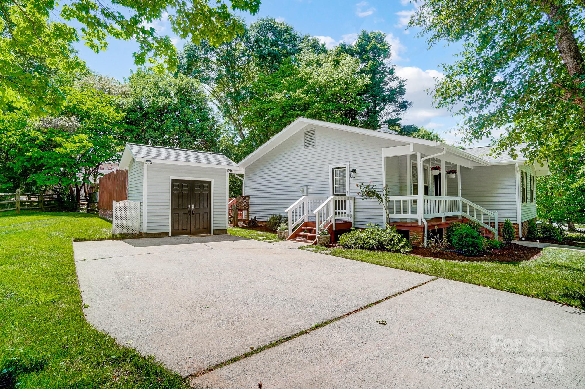 6510 Patchwork Circle Charlotte, NC 28270 - Photo 45 of 48 a view of a white house with a yard and plants