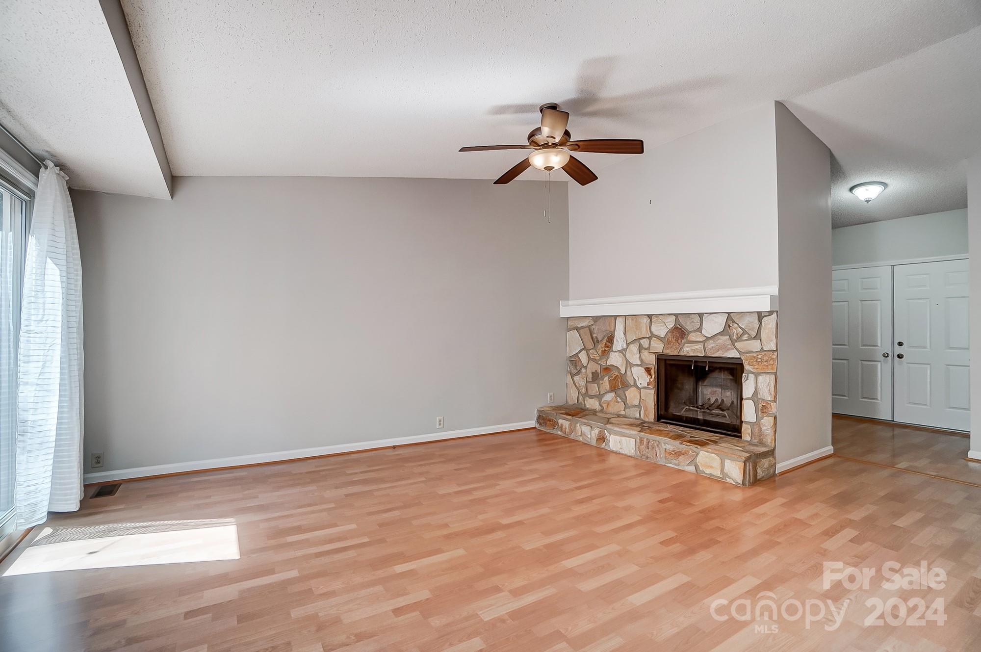 6510 Patchwork Circle Charlotte, NC 28270 - Photo 9 of 48 an empty room with a fireplace and fan