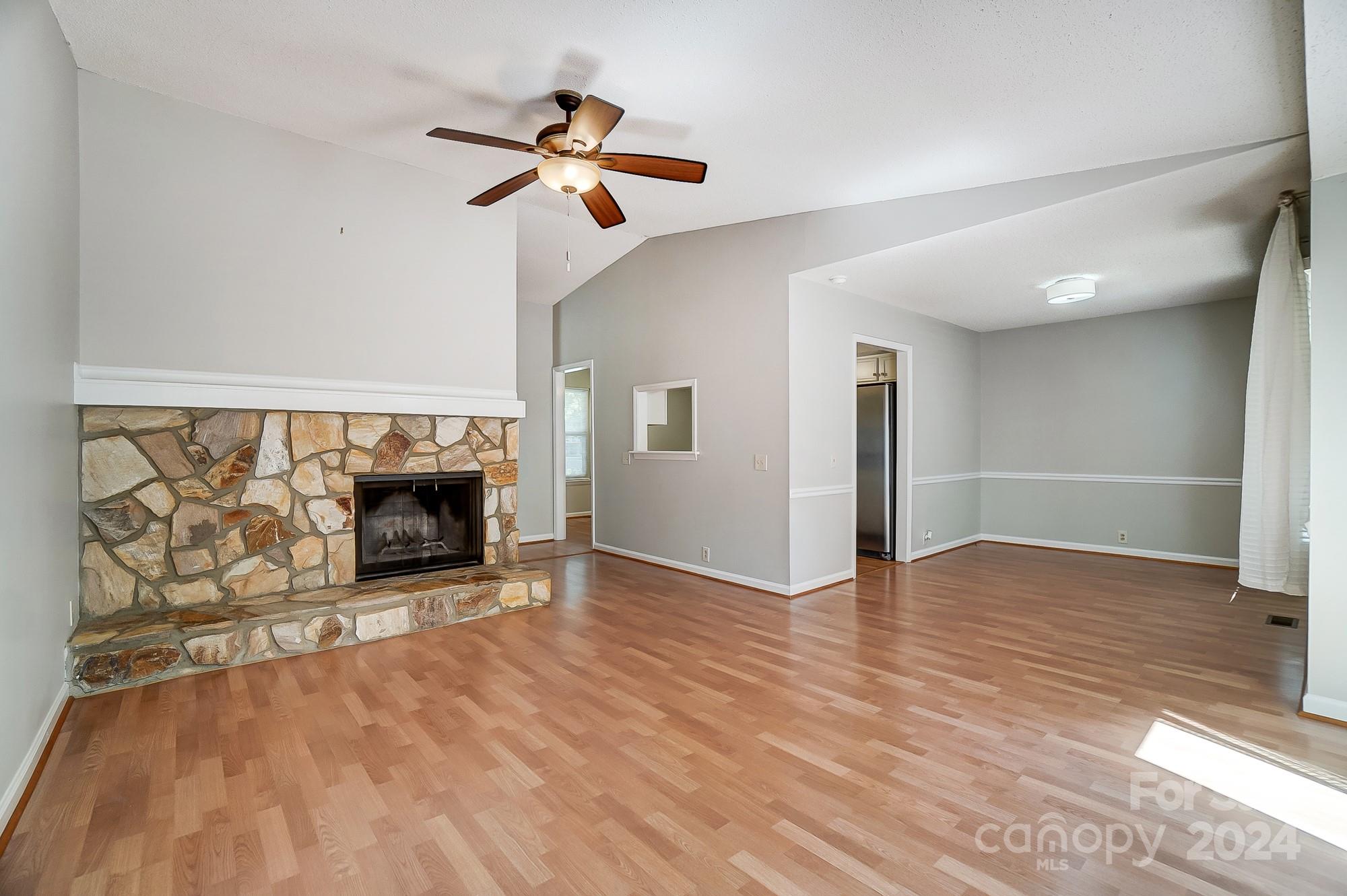 6510 Patchwork Circle Charlotte, NC 28270 - Photo 10 of 48 an empty room with wooden floor fireplace and windows