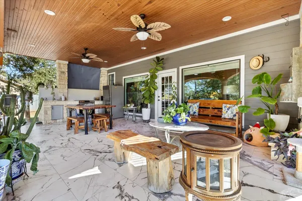 a view of a patio with table and chairs potted plants