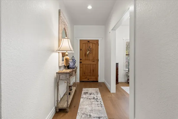 a view of hallway with wooden floor