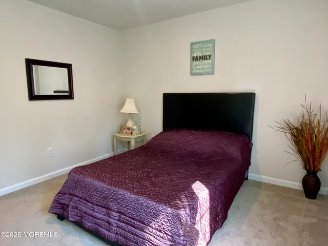 a bedroom with a bed and a potted plant