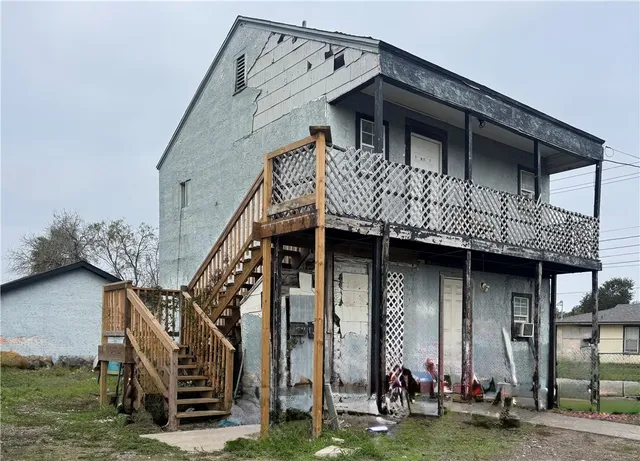 a view of a house with large windows and stairs