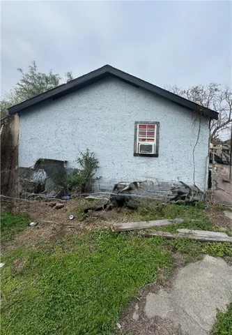 a backyard of a house with table and chairs