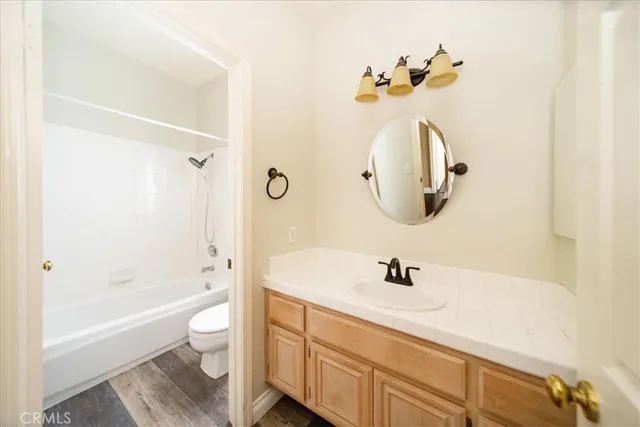 a bathroom with a sink a toilet and bathtub
