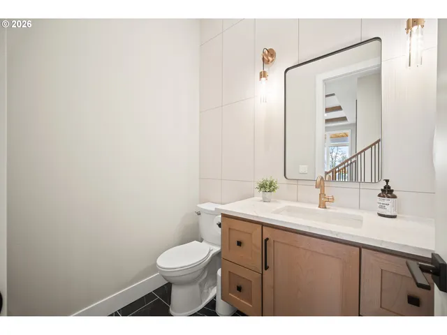 a bathroom with a toilet a sink and mirror