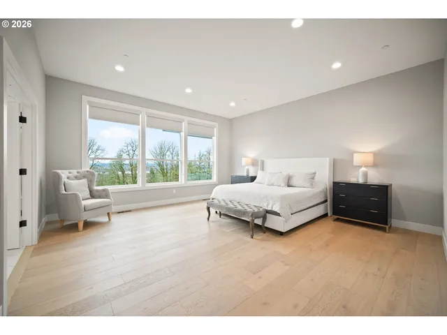 a spacious bedroom with a bed and a large window