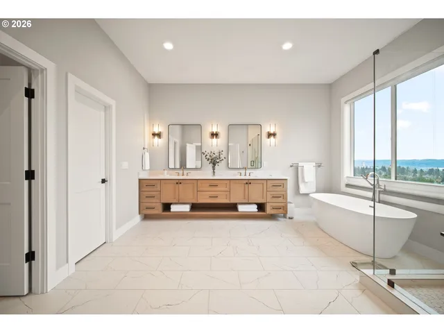 a spacious bedroom with a large bed and a chandelier