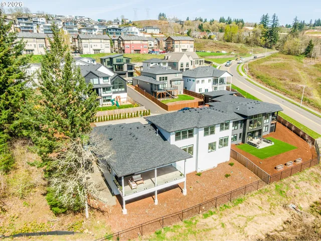 a view of a terrace with a table and chairs under an umbrella next to a yard