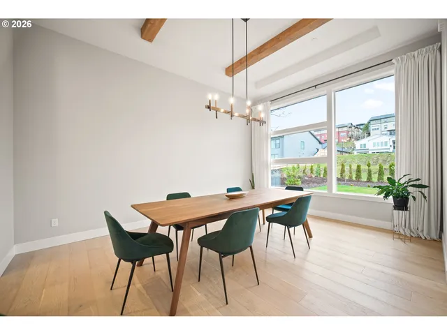 a dining room with furniture and wooden floor