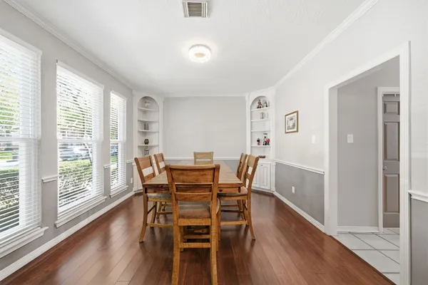 a view of a dining room with furniture and wooden floor