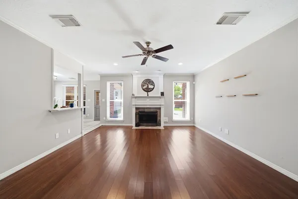 a large kitchen with cabinets and wooden floor