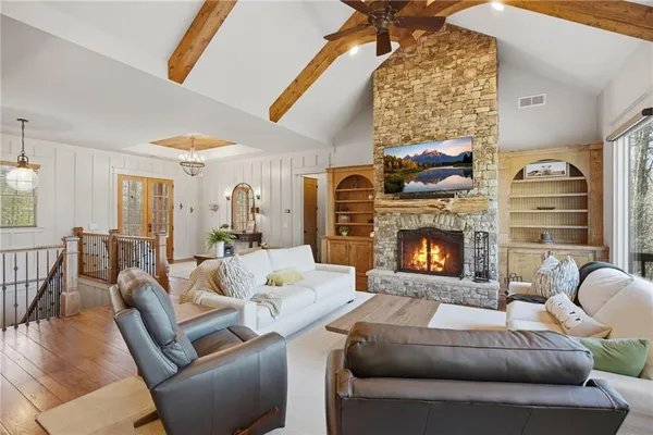 a spacious bedroom with a bed and wooden floor