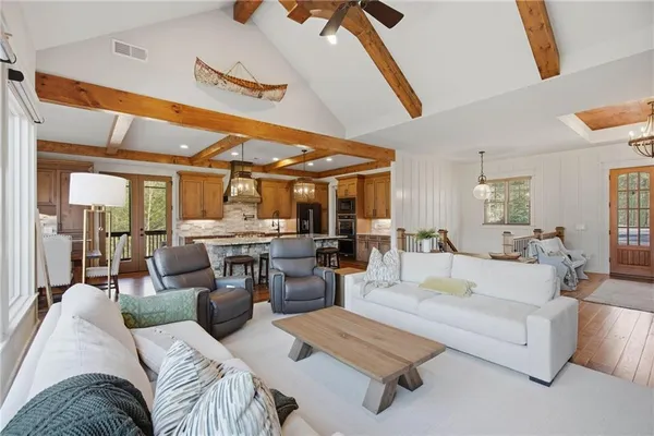 a spacious bathroom with a double vanity sink a large mirror and shower