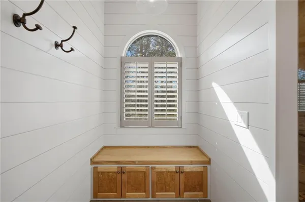 a living room with furniture a rug and a large window
