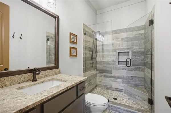 a view of a tennis court with lots of trees in the background