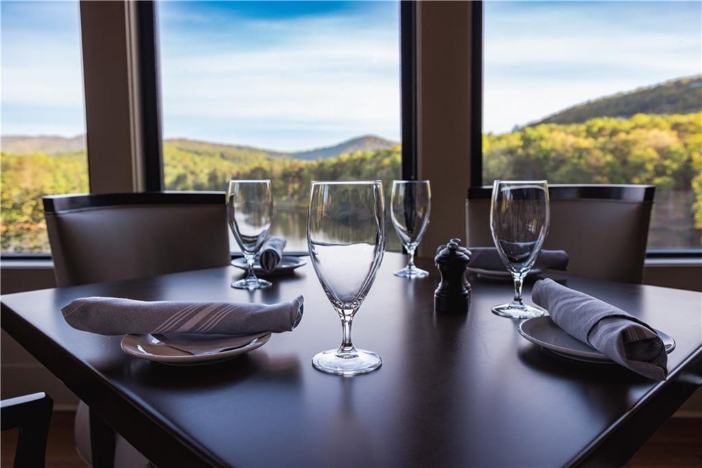 160 Wood Poppy View Big Canoe, GA 30143 - Photo 79 of 94 a view of a living room with furniture and floor to ceiling window
