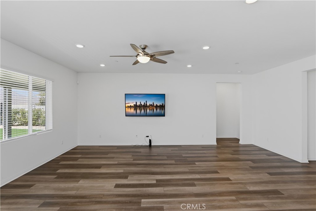 21159 Blue Jeans Court Riverside, CA 92507 - Photo 35 of 63 a view of a room with a ceiling fan and wooden floor