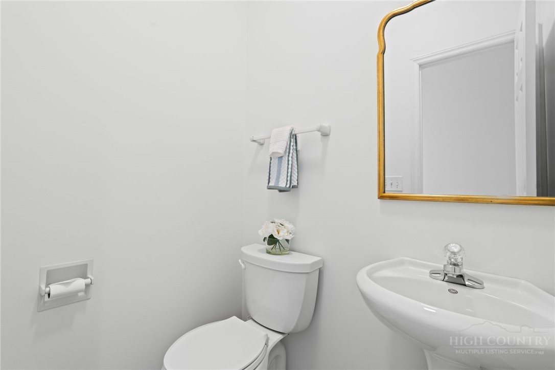 480 North Ridge Circle Boone, NC 28607 - Photo 23 of 50 a bathroom with a sink a toilet and mirror