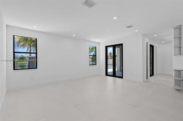 an empty room with windows and closet