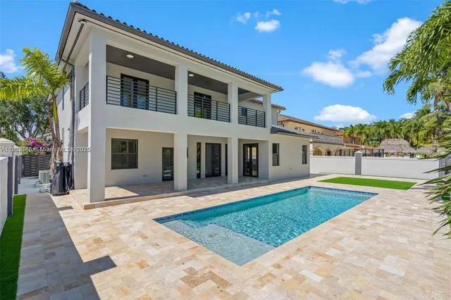 a view of a house with swimming pool and a yard