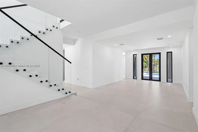 a view of an empty room with chandelier