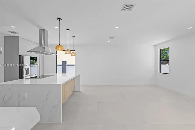 a view of kitchen with white cabinets and stove