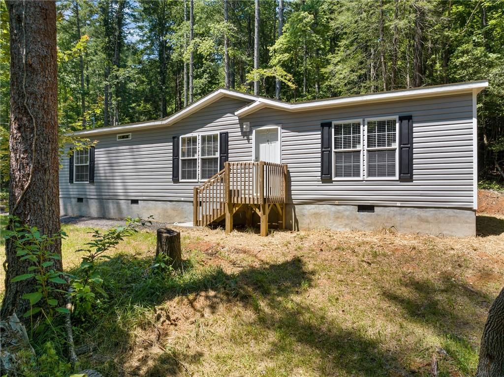 906 Mountain Cove Road Dahlonega, GA 30533 - Photo 1 of 1 a front view of a house with a yard